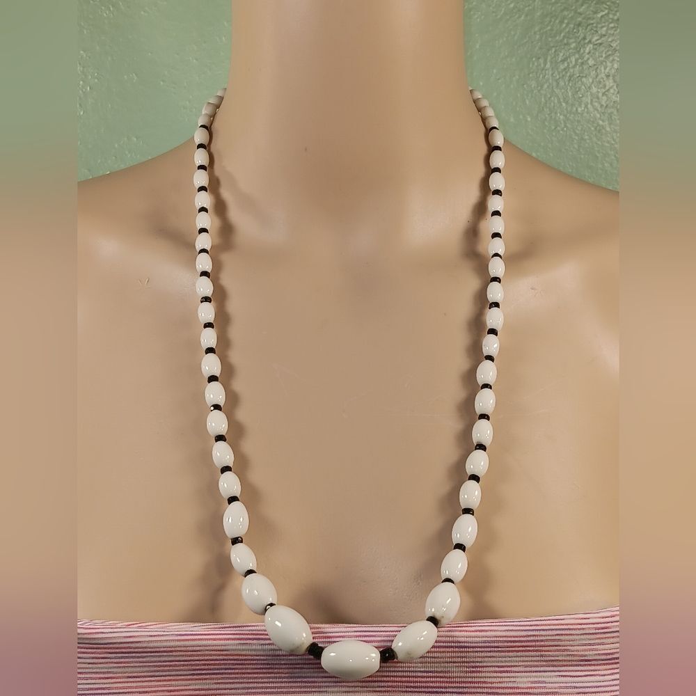 woman white and black necklace
